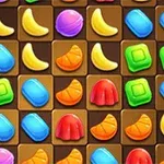 O grilă colorată cu forme variate, cum ar fi banane, jeleuri și alte obiecte multicolore