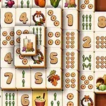 Piese de Mahjong cu simboluri tematice precum numere, sfeclă, dovleci și lumânări
